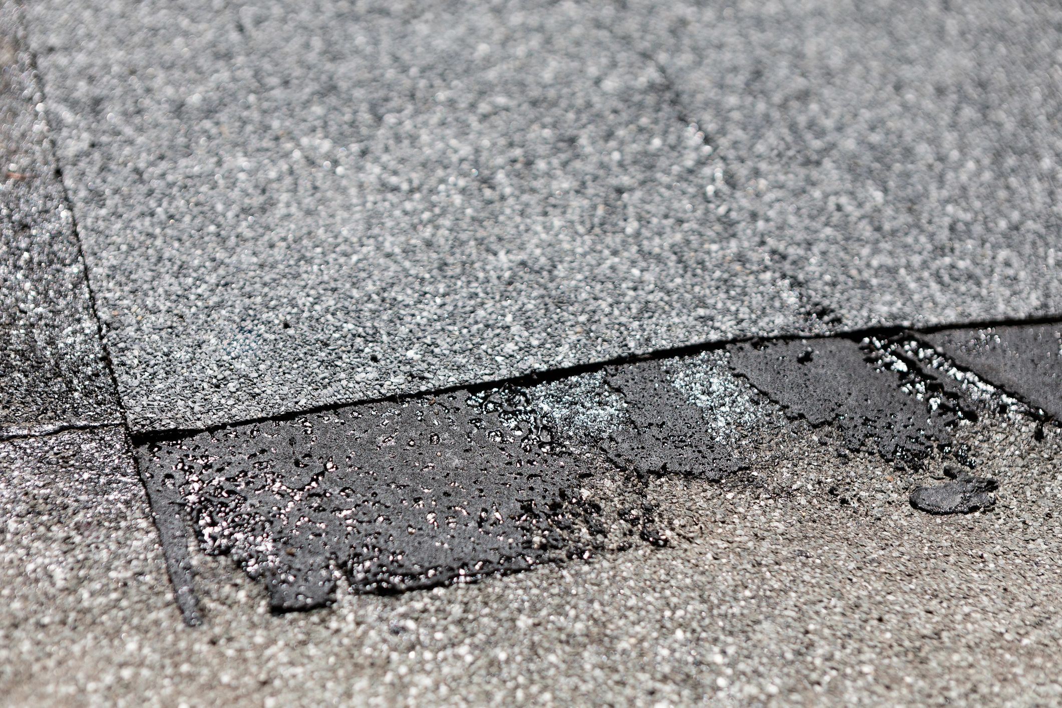 Close-up of worn roof surface showing repair area